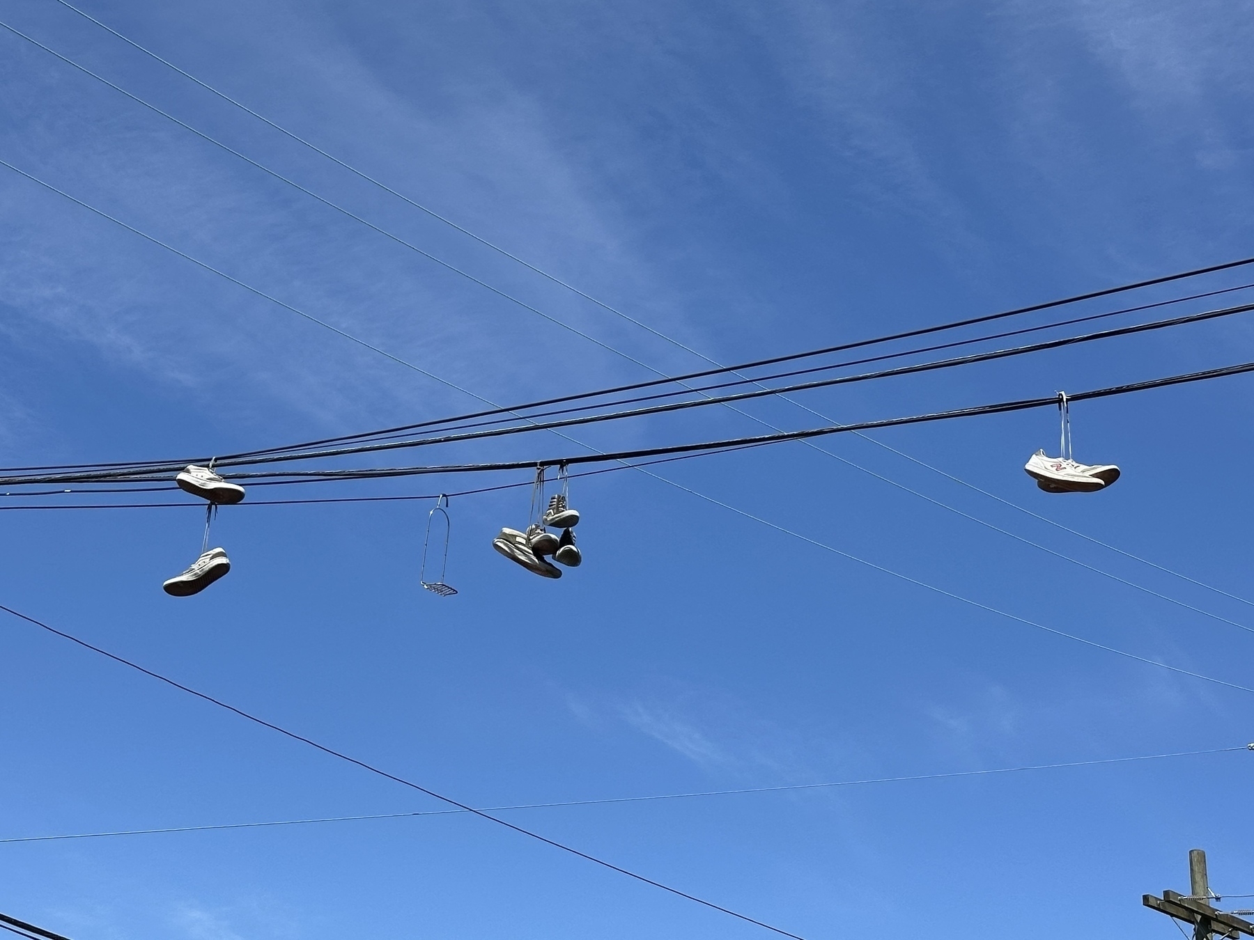 Sneakers hanging on a wire.