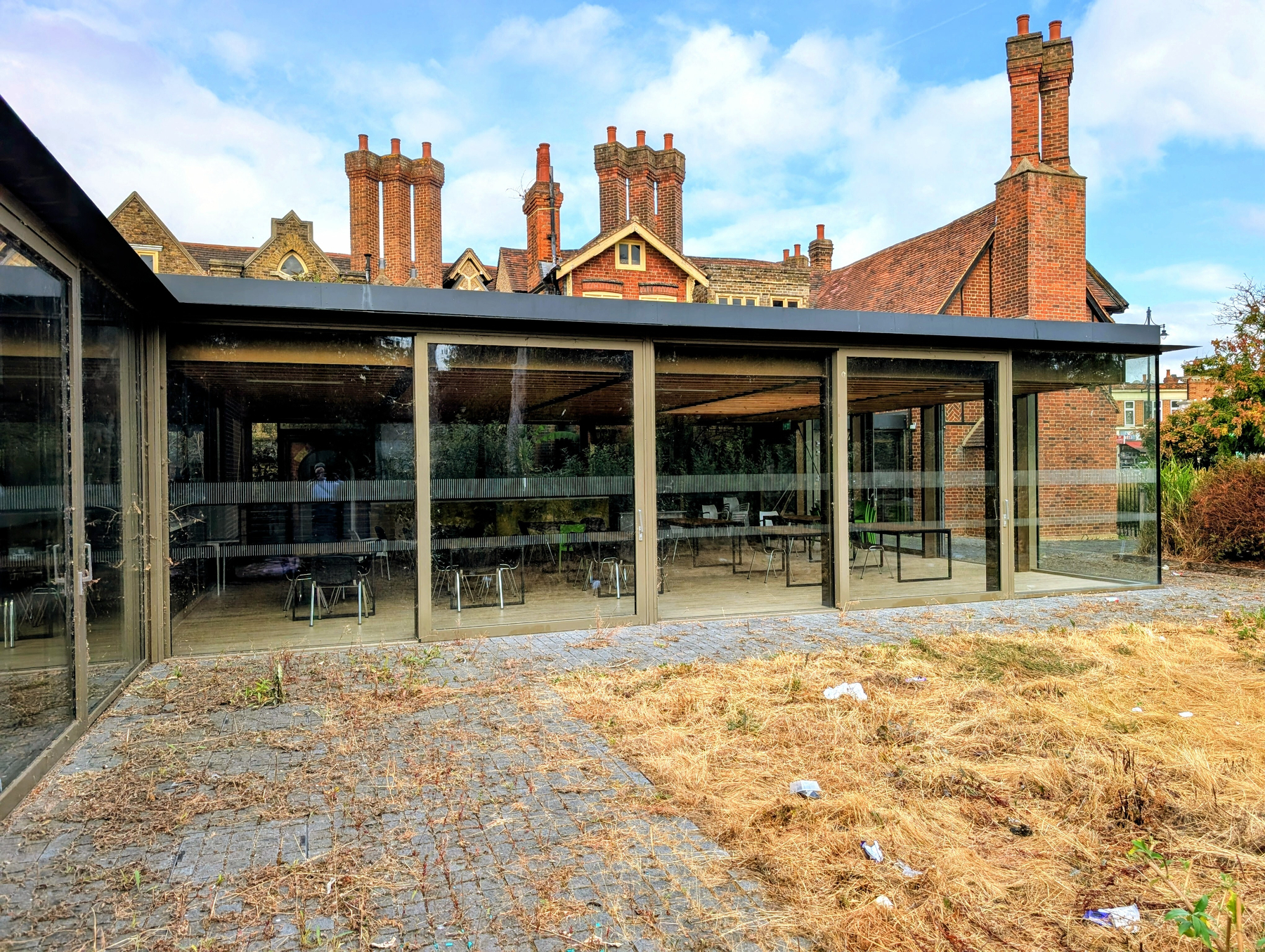 Modern glass extension building next to one of the oldest Tudor mansions in the country contain pristine kitchen and catering college equipment and furniture.
