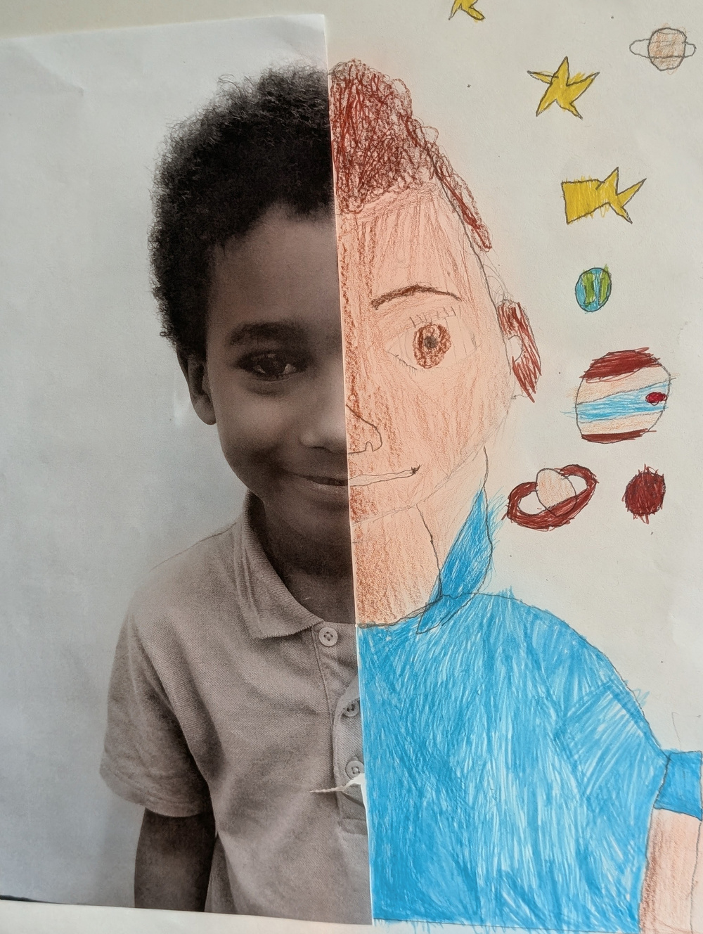 Half of a boy's face is shown in a black-and-white photograph, while the other half is a colorful hand-drawn portrait surrounded by drawings of planets and stars.